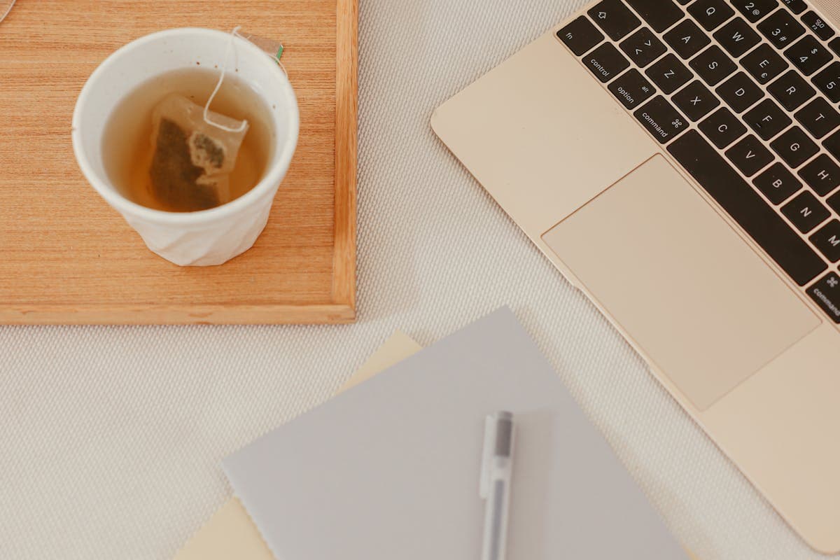 Laptop workspace with notebooks and productivity tools